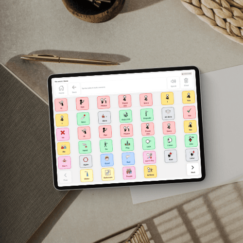 Tablet showing a clean communication grid with large tiles and a sentence bar